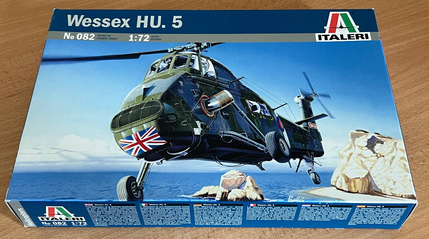 Model helicopter kit box for Wessex HU.5 by Italeri on a wooden surface