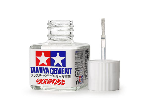 Tamiya Cement bottle with a small container and applicator on a white background