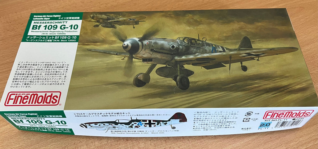 Model airplane kit box for Bf 109 G-10 by FineMolds on a wooden surface