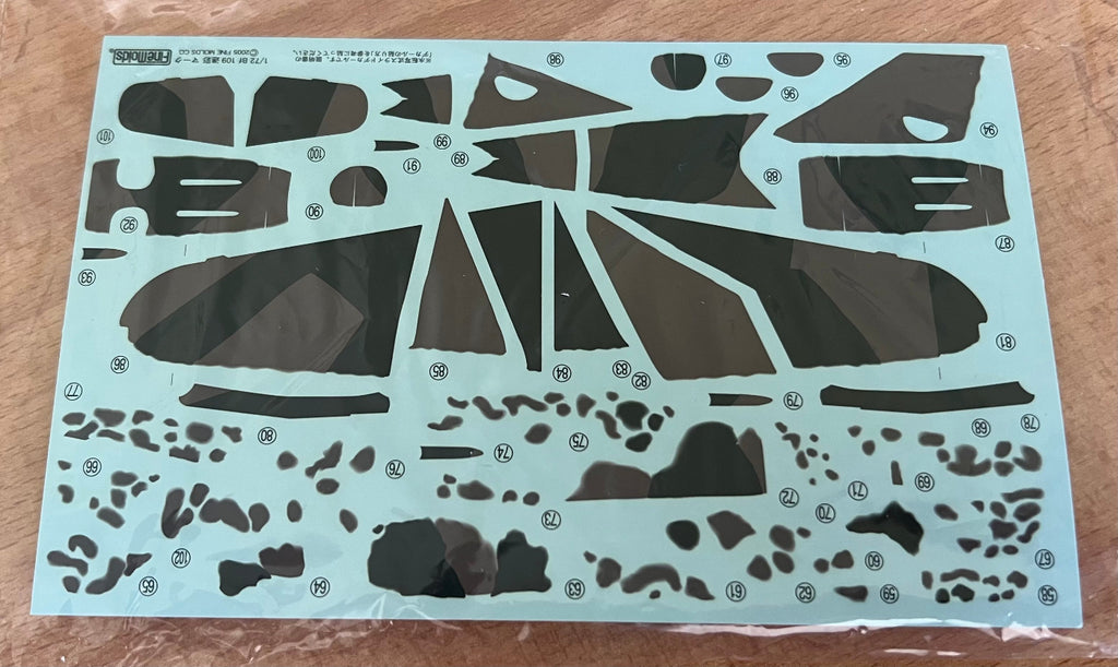 Model kit decals in a poly bag on a wooden background