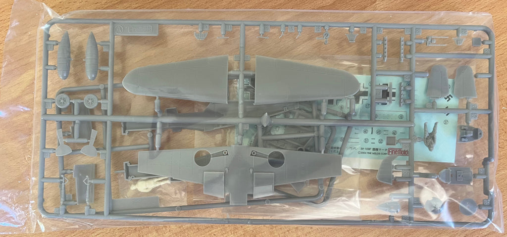 Model airplane kit on a wooden surface