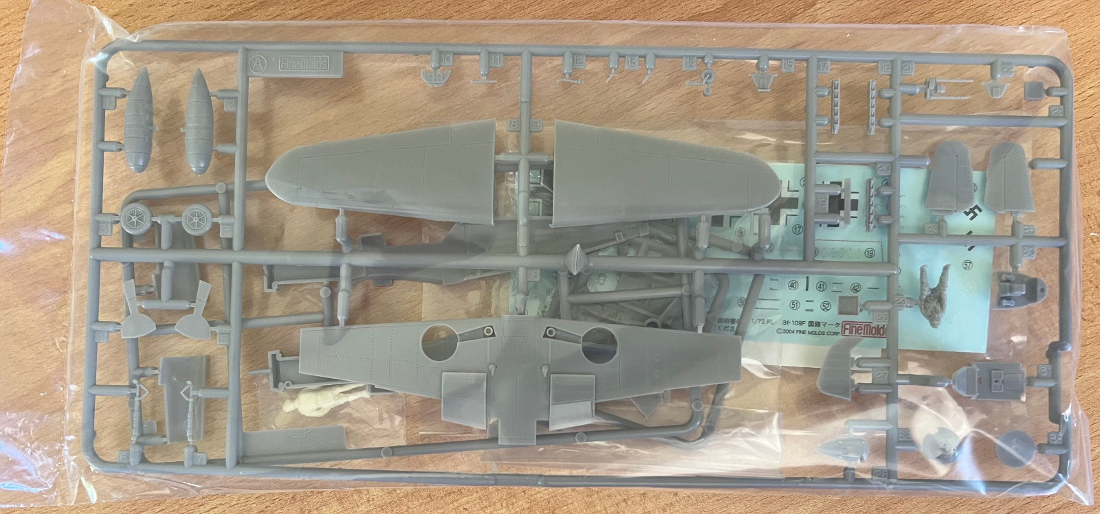 Model airplane kit on a wooden surface