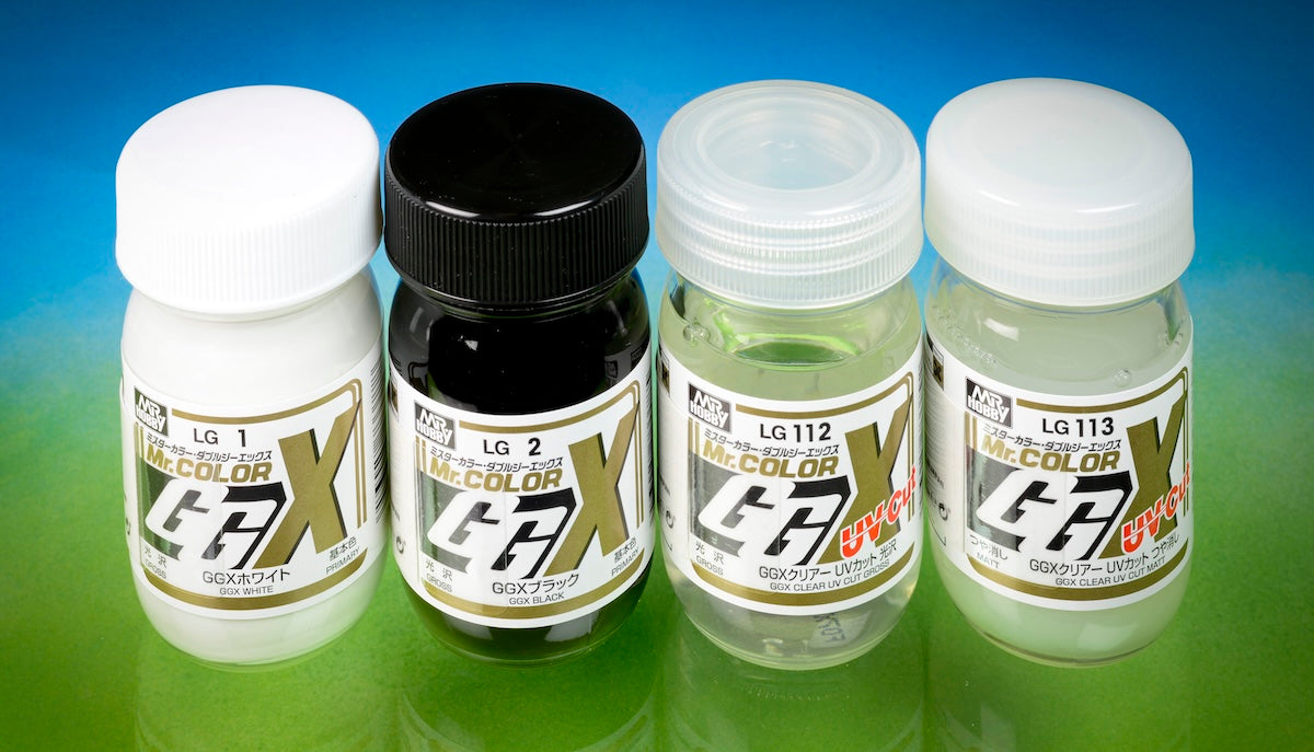 Four bottles of Mr. Color GGX paint with labels on a gradient blue and green background