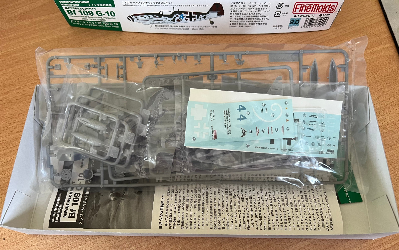 model kit parts in poly bag on a wooden background