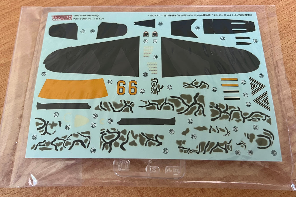 Decal sheet with various graphics and numbers on a clear background