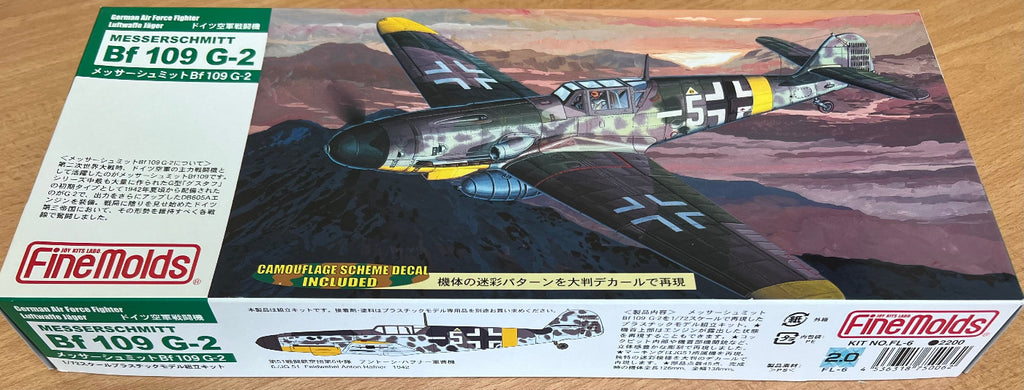 Model airplane kit of a Messerschmitt BF 109 G-2 on a wooden surface