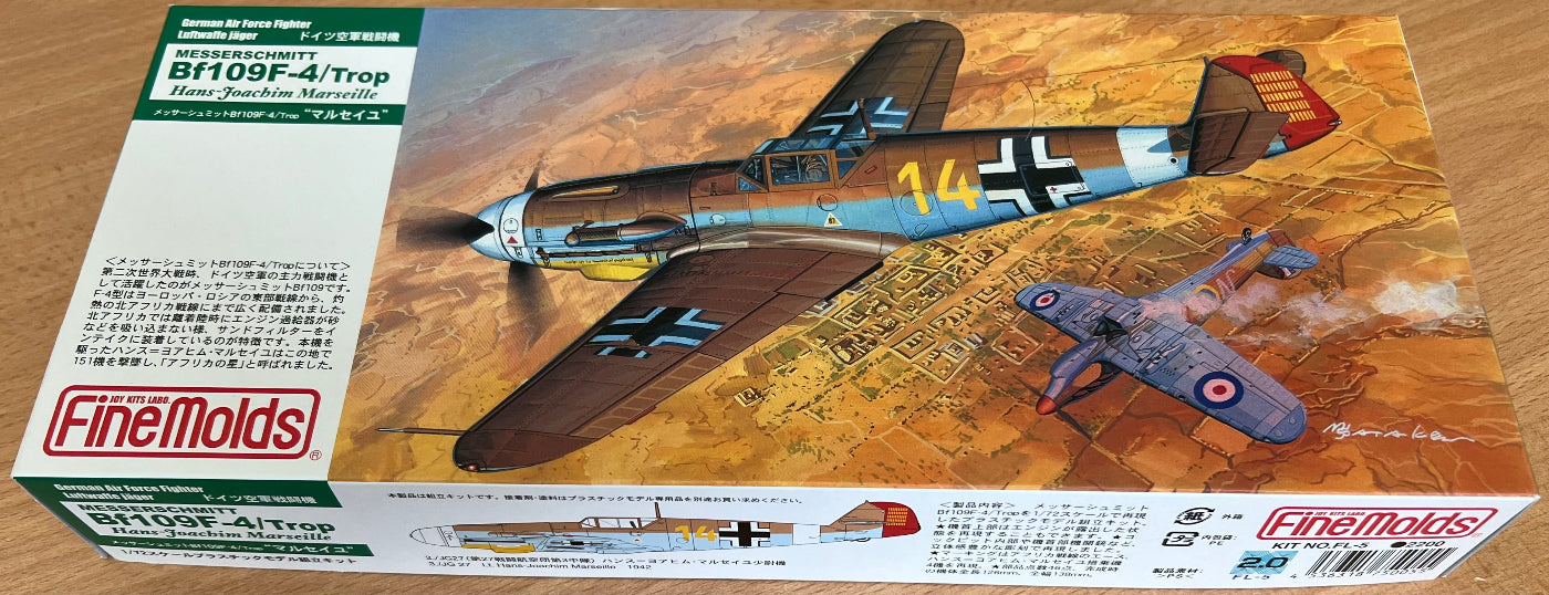 Model airplane kit box with a fighter plane design on a desert landscape background