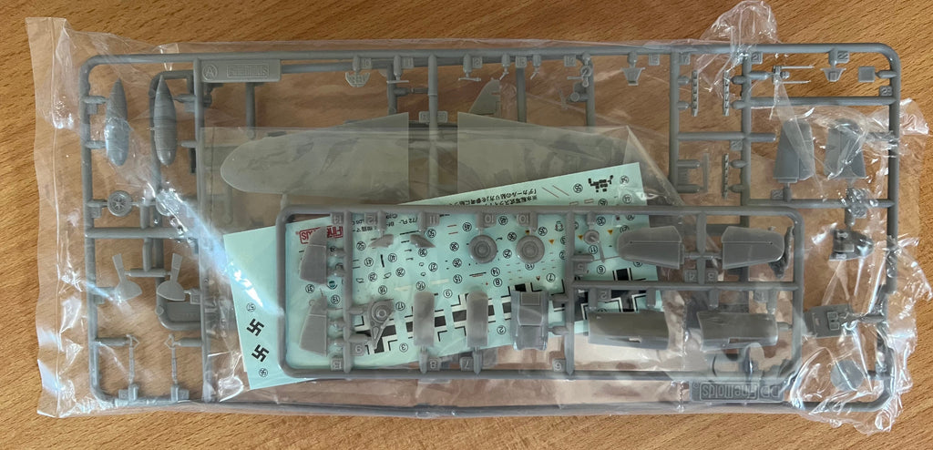 Model kit packaging on a wooden surface