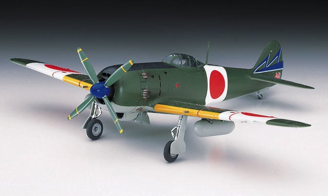 Model of a World War II-era fighter plane with a green body and red circle on a gray background