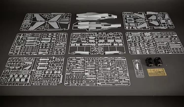 Collection of Kitty Hawk Su-34 model kit parts on a dark surface