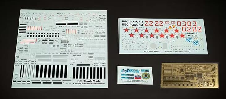 Set of Kitty Hawk Su-34 model decal sheets and stickers on a dark background