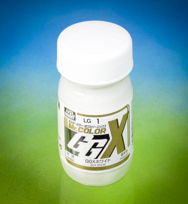 Bottle of Mr. Color GGX paint on a gradient blue to green background