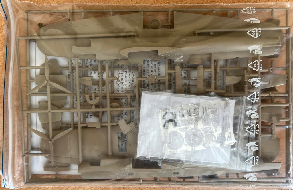Model kit packaging with unassembled parts and a clear plastic window