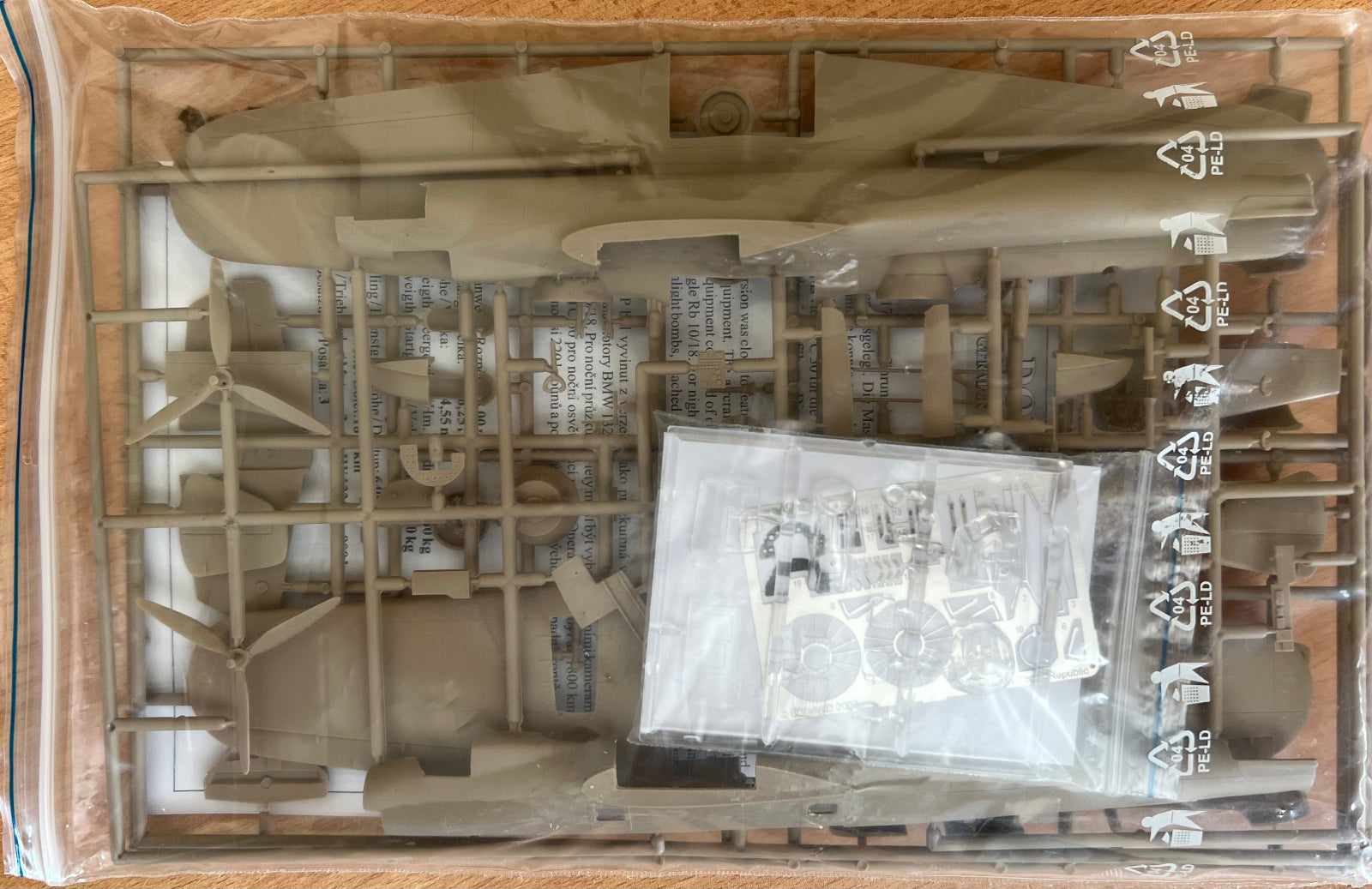 Model kit packaging with unassembled parts and a clear plastic window